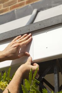 Woman making repairs on rental property