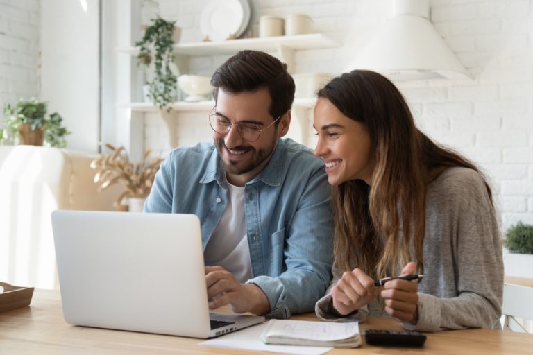 couple looks at laptop