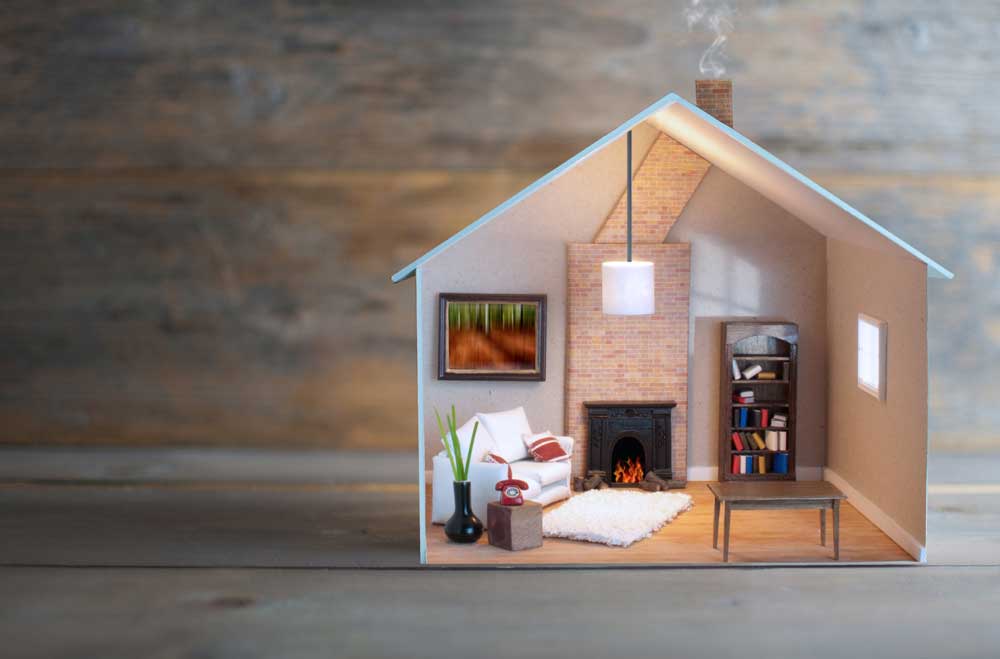 Miniature replica home, furnished, with a fireplace. Property management concept.