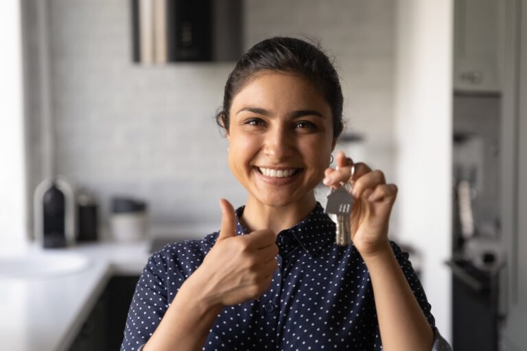 happy tenant holds apartment keys