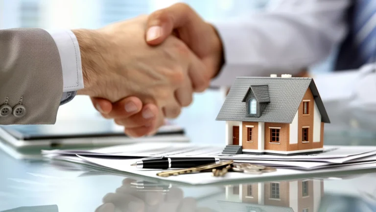 two hands shaking over a home contract