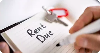 Rent Due’ handwritten on paper, pen visible in the background.