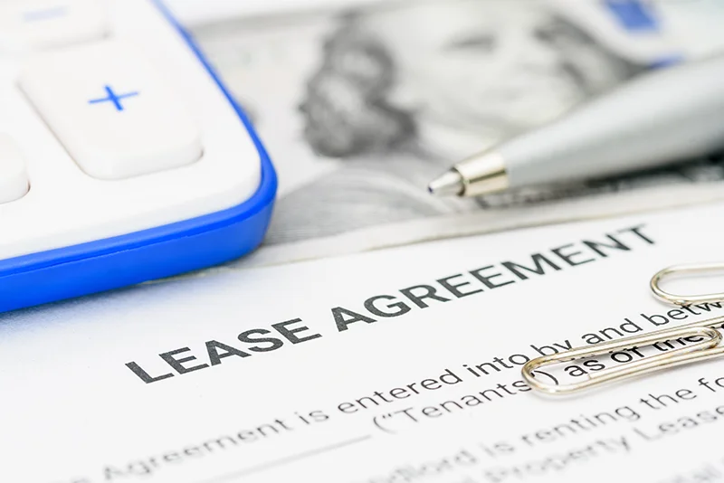A printed lease agreement and a pen.