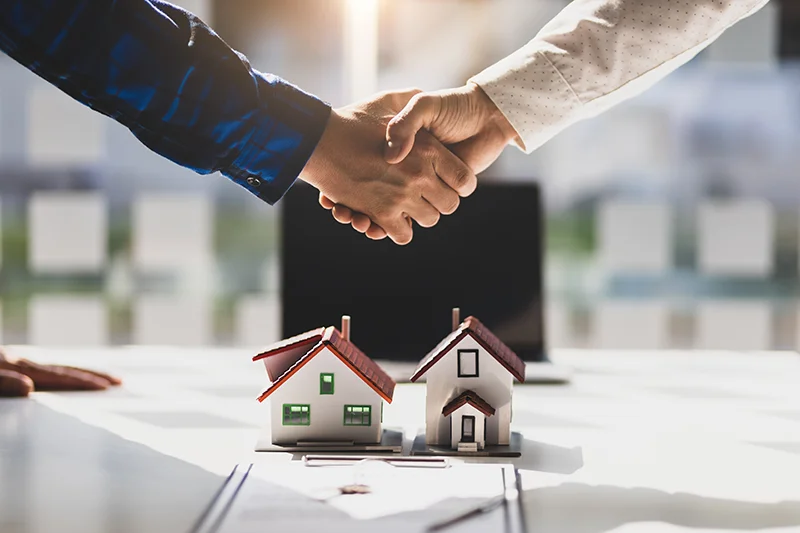 Property manager and landlord shaking hands.