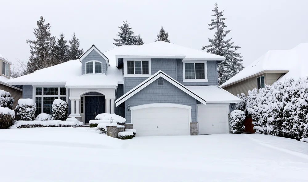 A rental home in winter time, surrounded by snow.