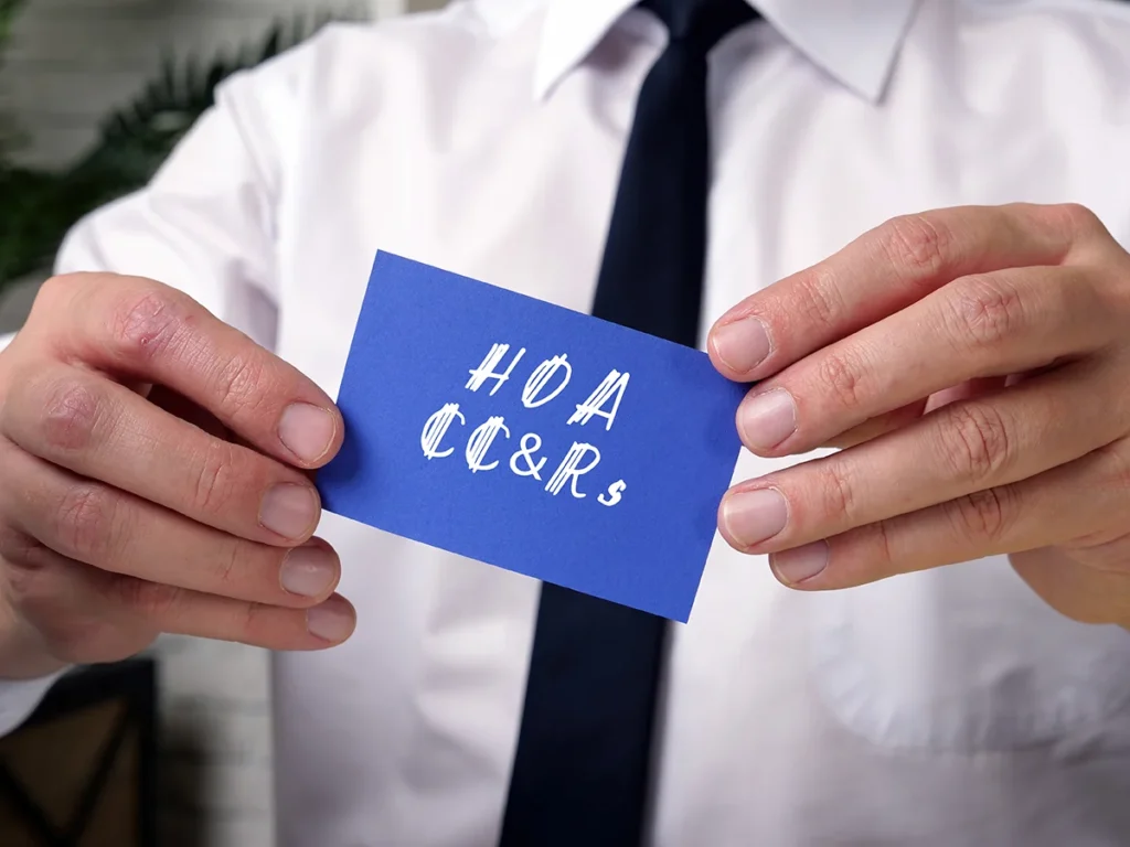 Person holding a card that reads HOA CC&Rs