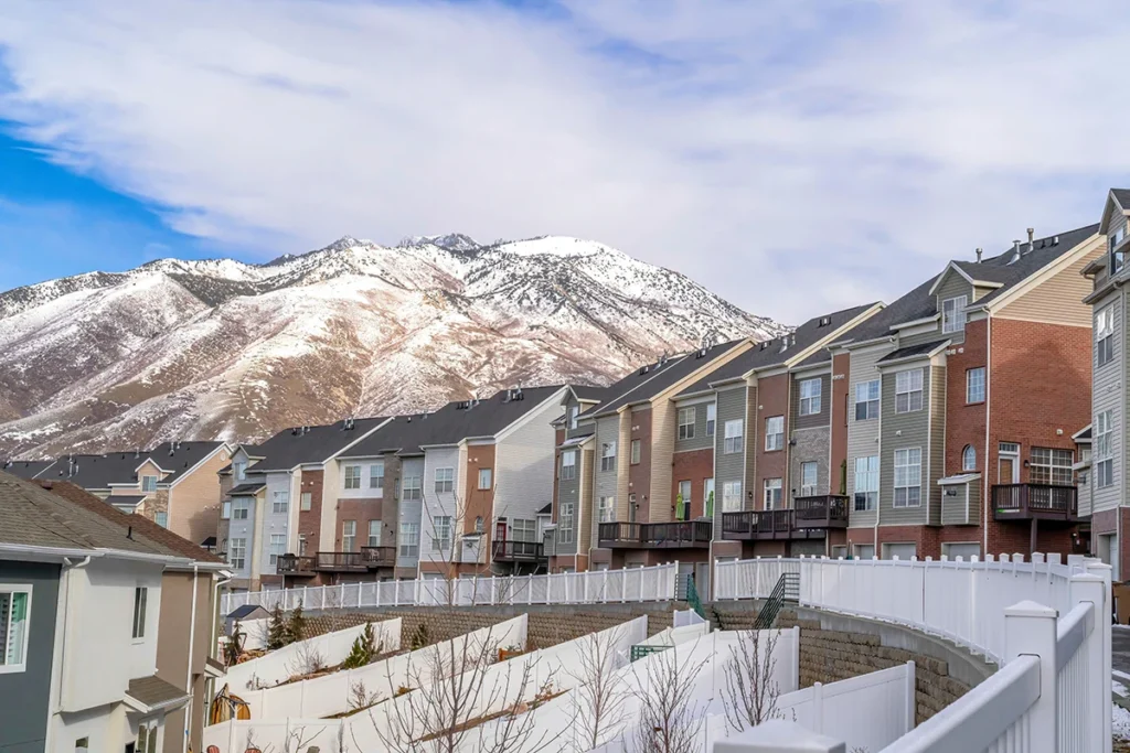 Row of townhomes with mountain backdrop.