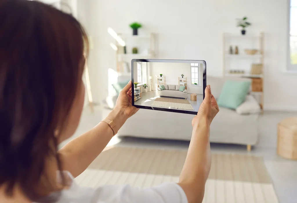 woman photographing rental home with tablet.