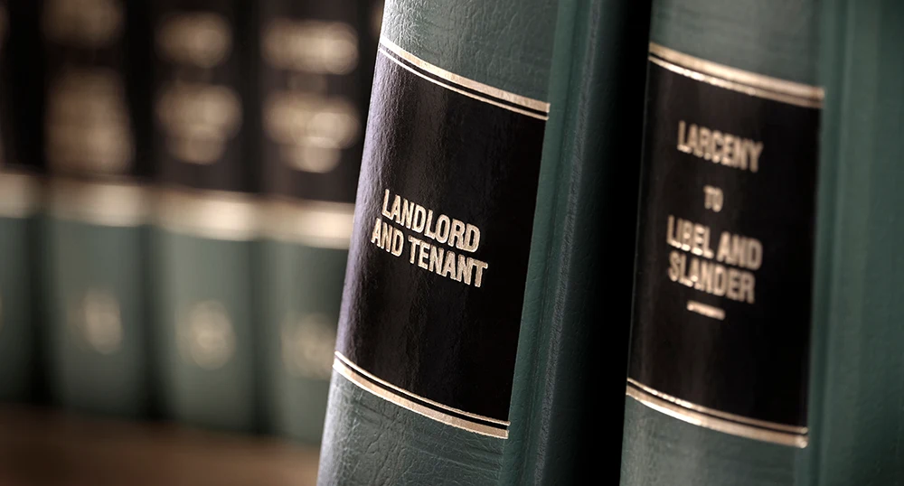 closeup photograph of some law books, featuring a landlord and tenant volume.