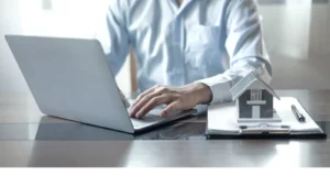 Landlord going over insurance documents on a laptop.