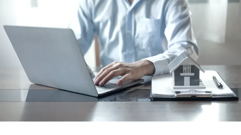 Landlord going over insurance documents on a laptop.