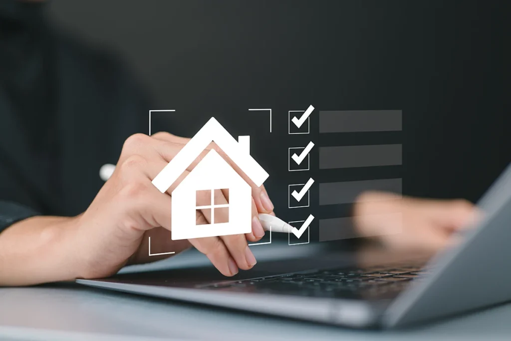 Image of a house in the foreground with boxes checked off. Person's hand in the background ticking off the boxes.