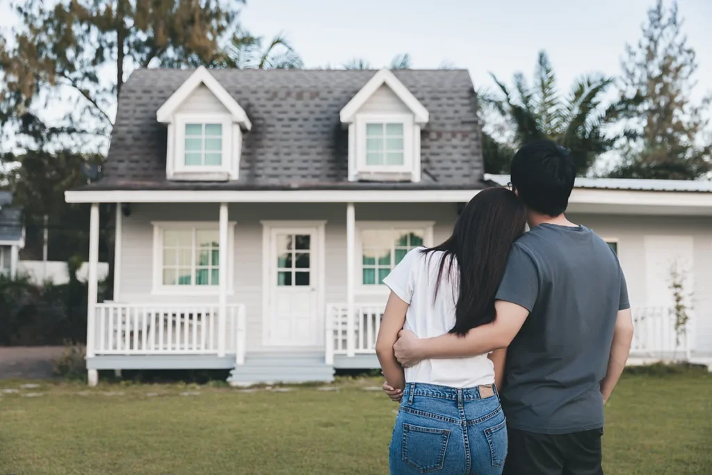 couple pictured standing in the foreground, facing an accessory dwelling unit in the background